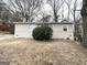 Cozy home with brick accents and a mature bush in the front yard at 312 Fairburn Nw Rd, Atlanta, GA 30331