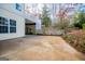 Concrete patio area beneath a deck with wooded backyard at 7364 N Mitchell Ct, Villa Rica, GA 30180