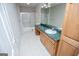 Bathroom with a shower-tub combo, white tile floor, and wood vanity at 7364 N Mitchell Ct, Villa Rica, GA 30180