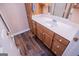 Bathroom featuring wood-look flooring, wooden cabinets and a white countertop with sink at 7364 N Mitchell Ct, Villa Rica, GA 30180