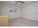 Cozy bedroom with neutral carpeting, a ceiling fan, and a bright window at 7364 N Mitchell Ct, Villa Rica, GA 30180