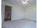 Bedroom featuring carpet floors, ceiling fan, and an open doorway at 7364 N Mitchell Ct, Villa Rica, GA 30180