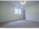 Bedroom with carpet flooring, a ceiling fan, and a window providing natural light at 7364 N Mitchell Ct, Villa Rica, GA 30180