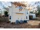 Exterior view of a yellow two-story home with a stone retaining wall at 7364 N Mitchell Ct, Villa Rica, GA 30180