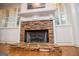 Close-up of the stone fireplace with a decorative mantel and hearth, flanked by built-in cabinets at 7364 N Mitchell Ct, Villa Rica, GA 30180