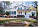 Charming two-story home boasts a welcoming front porch and beautifully landscaped front yard at 7364 N Mitchell Ct, Villa Rica, GA 30180