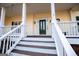 Inviting front porch with white railings and dark wood flooring at 7364 N Mitchell Ct, Villa Rica, GA 30180