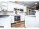 Contemporary kitchen with gray countertops, stainless steel appliances, and white cabinetry at 7364 N Mitchell Ct, Villa Rica, GA 30180