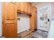 Laundry room with wood-look flooring, wooden cabinets and a door to the outside at 7364 N Mitchell Ct, Villa Rica, GA 30180