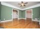 Inviting living room with wood floors, crown molding, and multiple entryways at 7364 N Mitchell Ct, Villa Rica, GA 30180