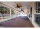 Spacious covered porch with multiple ceiling fans at 7364 N Mitchell Ct, Villa Rica, GA 30180