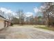 Long driveway leading to the home, surrounded by mature trees and natural landscape at 465 Camelot Dr, Fayetteville, GA 30214