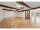 Bright living room featuring hardwood floors, wood beam accents and large windows at 465 Camelot Dr, Fayetteville, GA 30214