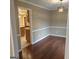 Open dining room with hardwood floors and an elegant light fixture next to the kitchen at 10020 Crystal Ter, Jonesboro, GA 30238