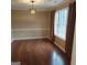 Elegant dining room with rich hardwood floors, decorative trim, and a modern chandelier at 10020 Crystal Ter, Jonesboro, GA 30238