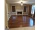 Spacious living room boasts a cozy fireplace, rich hardwood floors, and abundant natural light at 10020 Crystal Ter, Jonesboro, GA 30238