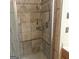 Tiled shower with built-in shelving and glass door at 10020 Crystal Ter, Jonesboro, GA 30238