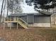 Back of home featuring new wooden deck with metal railing and steps at 115 Paces Way, Fayetteville, GA 30215