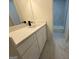 Bathroom with white vanity, black faucet, and marble-look tile flooring at 115 Paces Way, Fayetteville, GA 30215