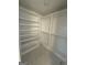 Custom walk-in closet with built-in shelves and hanging rods for optimal organization at 115 Paces Way, Fayetteville, GA 30215