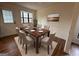 Dining room with wood table, six upholstered chairs, and large window at 115 Paces Way, Fayetteville, GA 30215