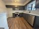 Modern kitchen with stainless steel appliances, white subway tile backsplash, and dark cabinets at 115 Paces Way, Fayetteville, GA 30215