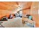 View of the spacious attic featuring wood paneled walls, carpeted floors, and a ceiling fan at 125 Keyland Dr, Fayetteville, GA 30215