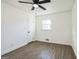 Clean empty bedroom features hard surface floors, neutral paint, a ceiling fan, and a large window at 6630 Hawes Dr, Lithonia, GA 30058