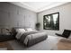 Sleek bedroom with a gray accent wall, a modern bed, and a large window with natural light at 532 Saint Sambar Dr, Ellenwood, GA 30294