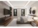 Contemporary bedroom featuring a stylish media center, hardwood floors, and large windows at 532 Saint Sambar Dr, Ellenwood, GA 30294