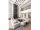 Grand living room with a black marble fireplace, comfortable sofas, and a soaring ceiling with modern lighting at 532 Saint Sambar Dr, Ellenwood, GA 30294