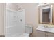 Bright bathroom featuring a white shower stall, toilet, and vanity with a neutral color scheme at 6973 Stephens Dr, Rex, GA 30273