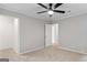 Bedroom featuring a ceiling fan, with an adjacent room that is accessible through the door at 6973 Stephens Dr, Rex, GA 30273