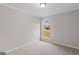 Cozy bedroom with neutral carpet, arched window providing ample natural light, and modern finishes at 6973 Stephens Dr, Rex, GA 30273