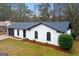 Charming single-story brick home with a well-manicured lawn and a dark-colored roof and trim at 6973 Stephens Dr, Rex, GA 30273