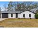 Charming single-story home with a brick exterior, arched windows, and well-manicured lawn at 6973 Stephens Dr, Rex, GA 30273
