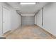 Spacious garage with a roll-up door and ample room for parking and storage at 6973 Stephens Dr, Rex, GA 30273