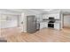 Bright kitchen with stainless steel appliances, granite countertops, and open layout to dining area at 6973 Stephens Dr, Rex, GA 30273