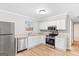 Bright kitchen featuring stainless steel appliances, granite countertops, and classic white cabinets at 6973 Stephens Dr, Rex, GA 30273