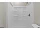 The shower stall is a clean white, with built in shelves, and modern fixtures at 6973 Stephens Dr, Rex, GA 30273
