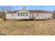 Back exterior with sun room, deck and well-maintained landscaping at 62 Honey Ln, Mcdonough, GA 30252