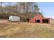 Red barn with multiple bays, offering ample storage and workspace at 62 Honey Ln, Mcdonough, GA 30252