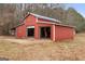 Large red barn with multiple bays, offering ample storage and workspace at 62 Honey Ln, Mcdonough, GA 30252