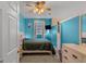 The vibrant blue bedroom features neutral carpet, closet and TV at 62 Honey Ln, Mcdonough, GA 30252