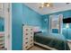 The vibrant blue bedroom features neutral carpet and light dresser at 62 Honey Ln, Mcdonough, GA 30252