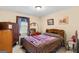 Bedroom with neutral carpet, wooden dresser, and framed paintings at 62 Honey Ln, Mcdonough, GA 30252