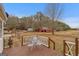 Inviting wooden deck with outdoor seating, perfect for enjoying the serene views of the backyard and its barn at 62 Honey Ln, Mcdonough, GA 30252