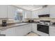 Bright kitchen featuring white cabinets, appliances, and a sink, creating a clean and functional cooking space at 62 Honey Ln, Mcdonough, GA 30252