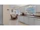 Well-lit kitchen with white cabinets, a dining table and ample counter space, perfect for cooking and entertaining at 62 Honey Ln, Mcdonough, GA 30252