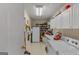 Bright laundry room with white appliances, ample shelving, and storage space for household essentials at 62 Honey Ln, Mcdonough, GA 30252